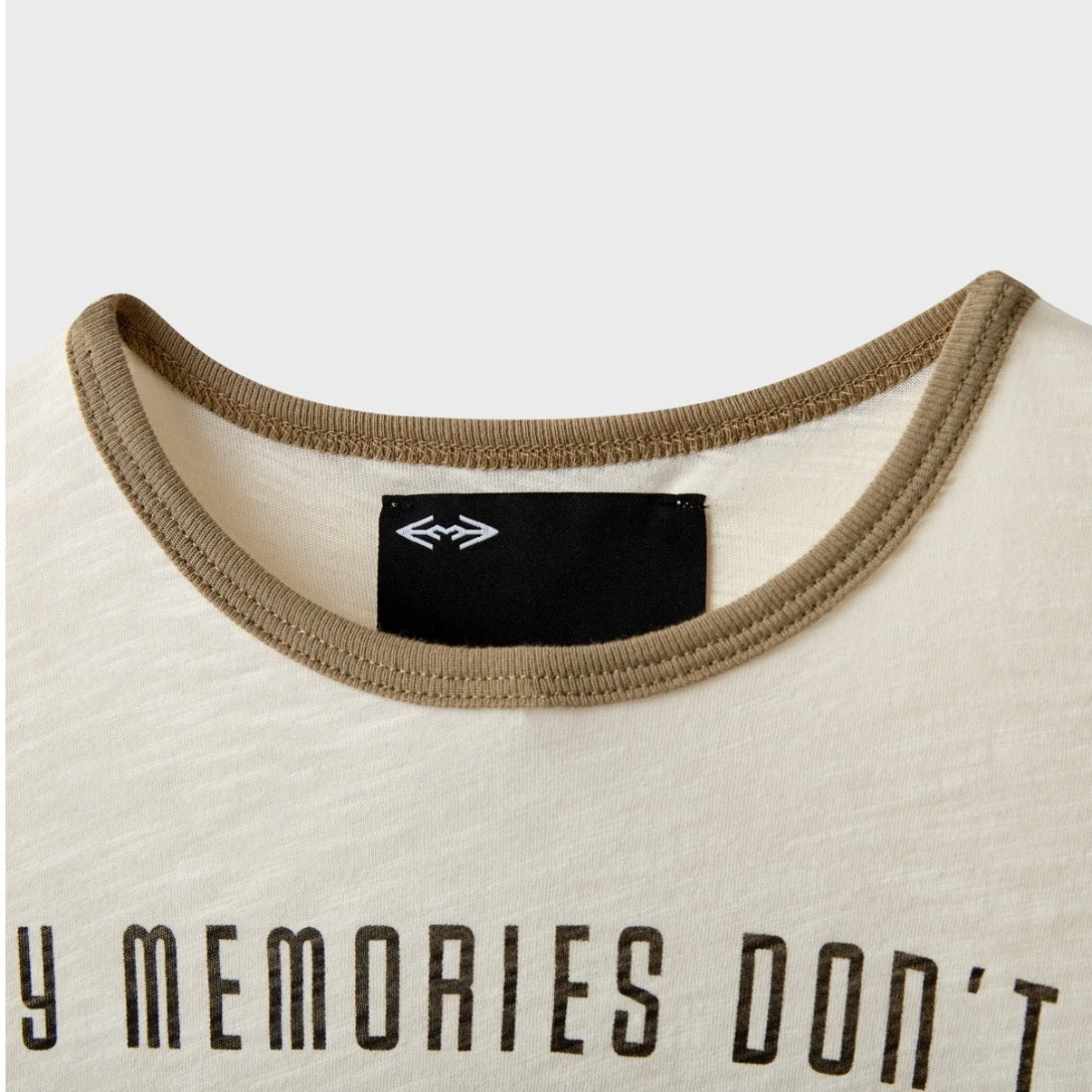 HMDD Boxer Baby Slub T-Shirt, close-up of the khaki ribbed ringer collar and black woven label above the chest print