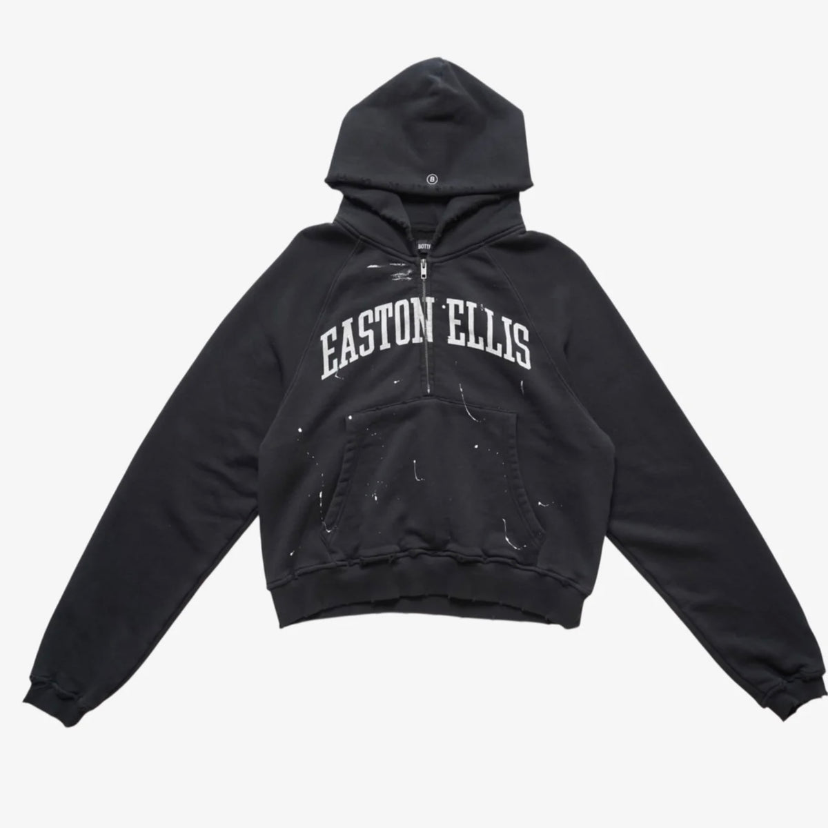 Bottega Desires Easton Ellis hooded half zip in washed black with white arched EASTON ELLIS lettering and white paint splatter, front view