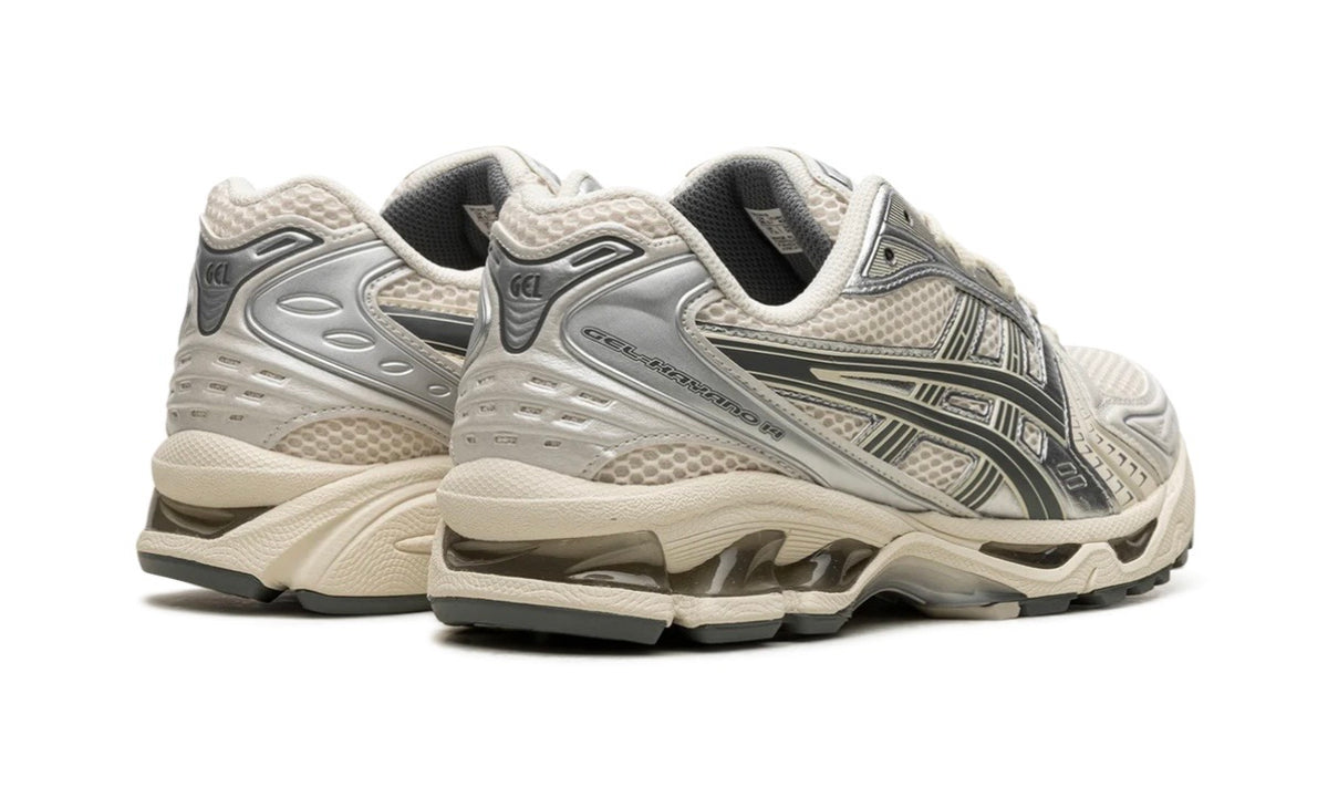 Pair of Asics Gel-Kayano 14 Birch Dark Pewter seen from the rear, showing the silver heel counters