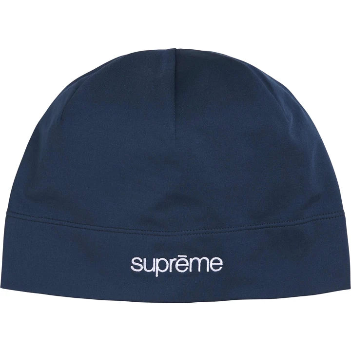 Supreme Base Layer beanie in smooth navy stretch fabric with a white Supreme logo at the front hem