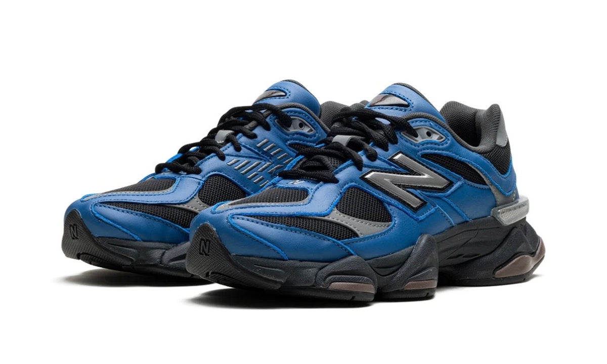 New Balance 9060 Dark Royal Brown, pair shown from the front with black laces and blue overlays