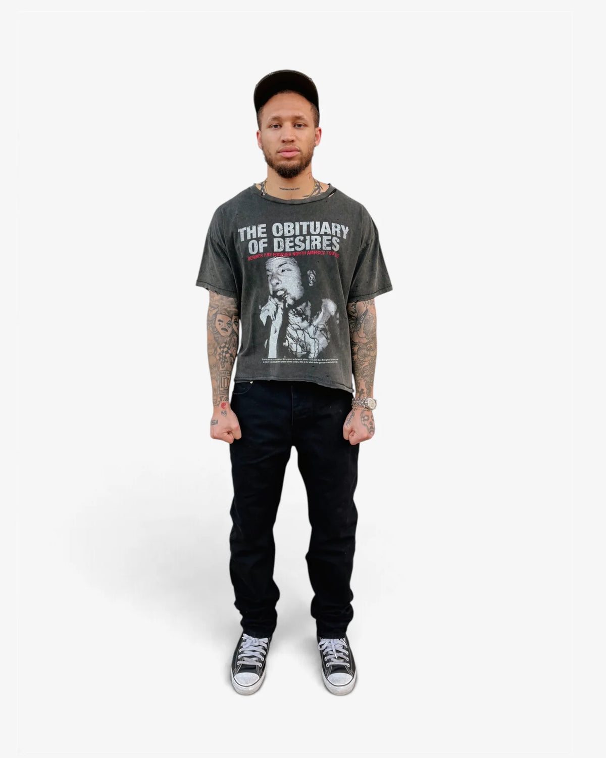 Model wearing the Obituary tee with black jeans, front view