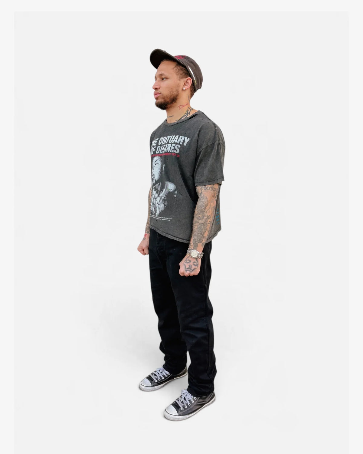 Model wearing the Obituary tee with black jeans, side view