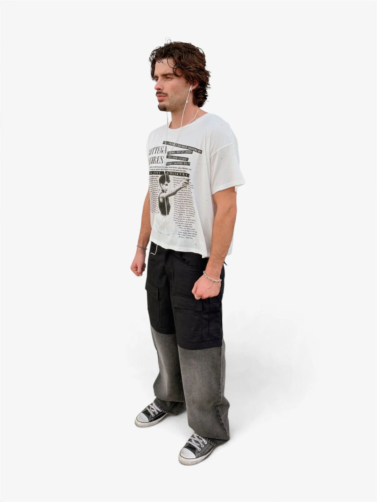 Model wearing the Interview tee with two-tone wide pants, three-quarter front view