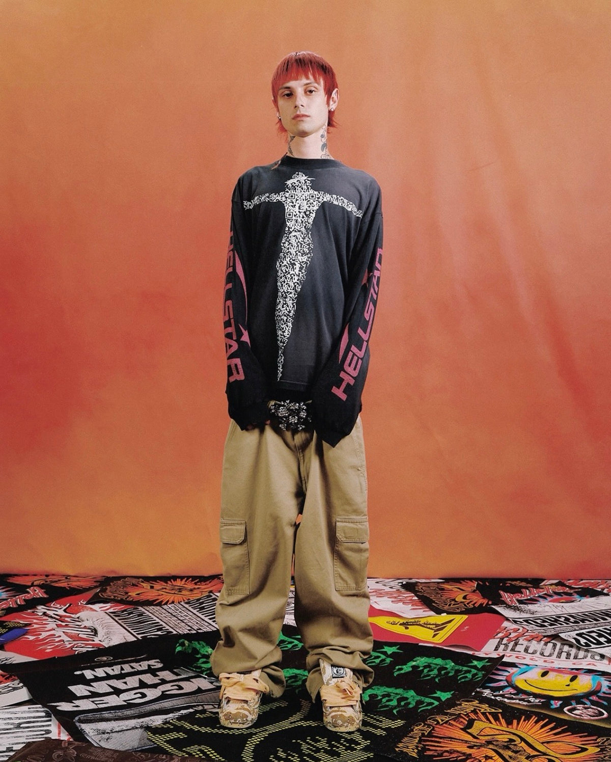 Hellstar Black QR Christ Long Sleeve worn with khaki cargo pants on an orange backdrop