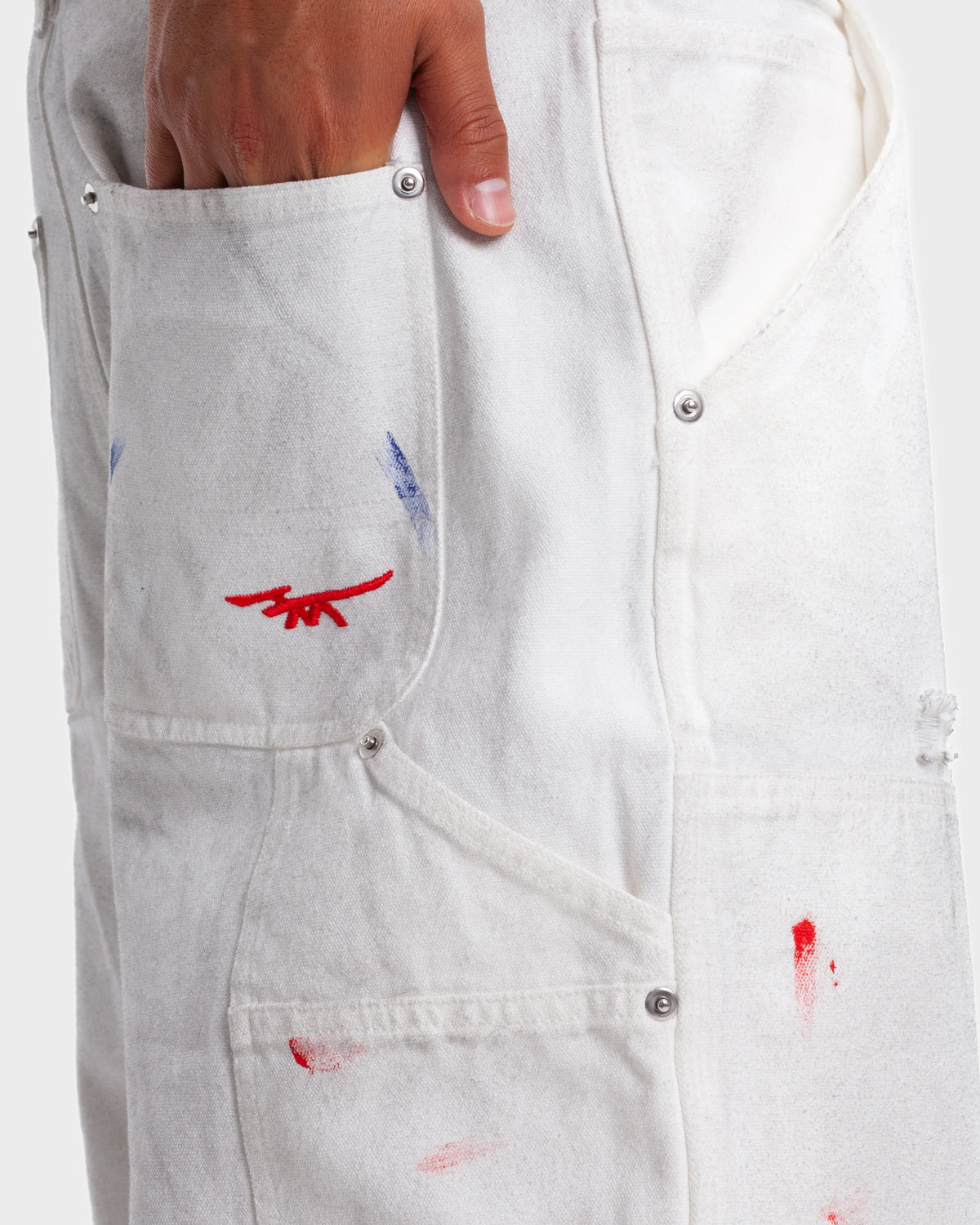 HMDD Big Ed Work Pants, close-up of the front pocket logo, paint flecks and hammer loop