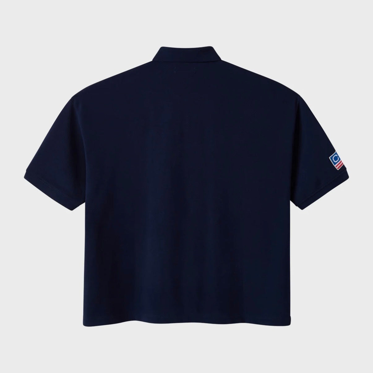 HMDD Glo Navy Polo, back of the navy polo, plain body with a small patch on the sleeve