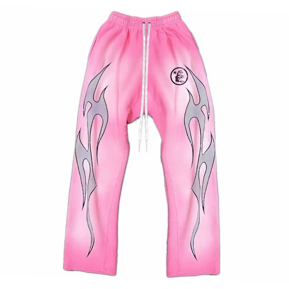 Hellstar Pink Flame Sweatpants front in faded pink with grey tribal flames and a circular seal
