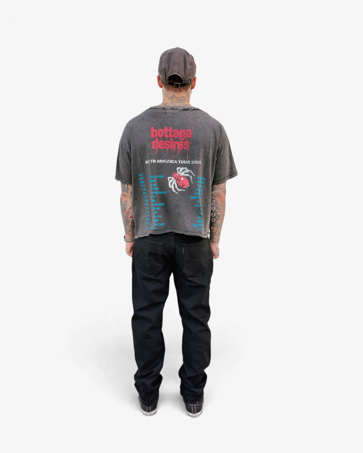 Model wearing the Obituary tee with black jeans, back view