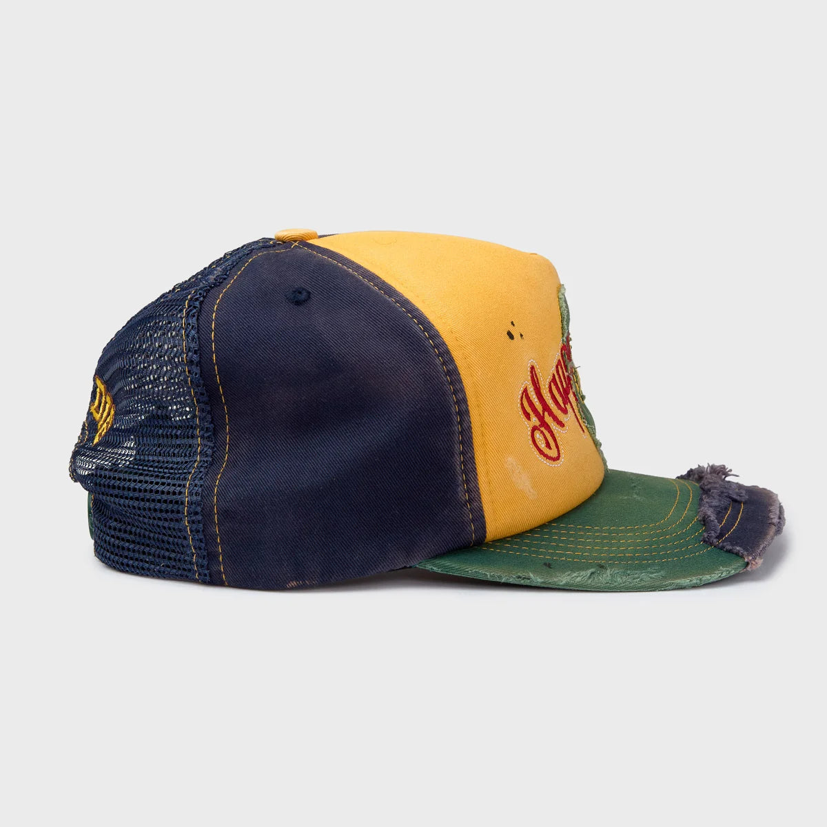 HMDD Yellow Sandlot Hat, side profile showing navy mesh panels, yellow front and frayed green brim