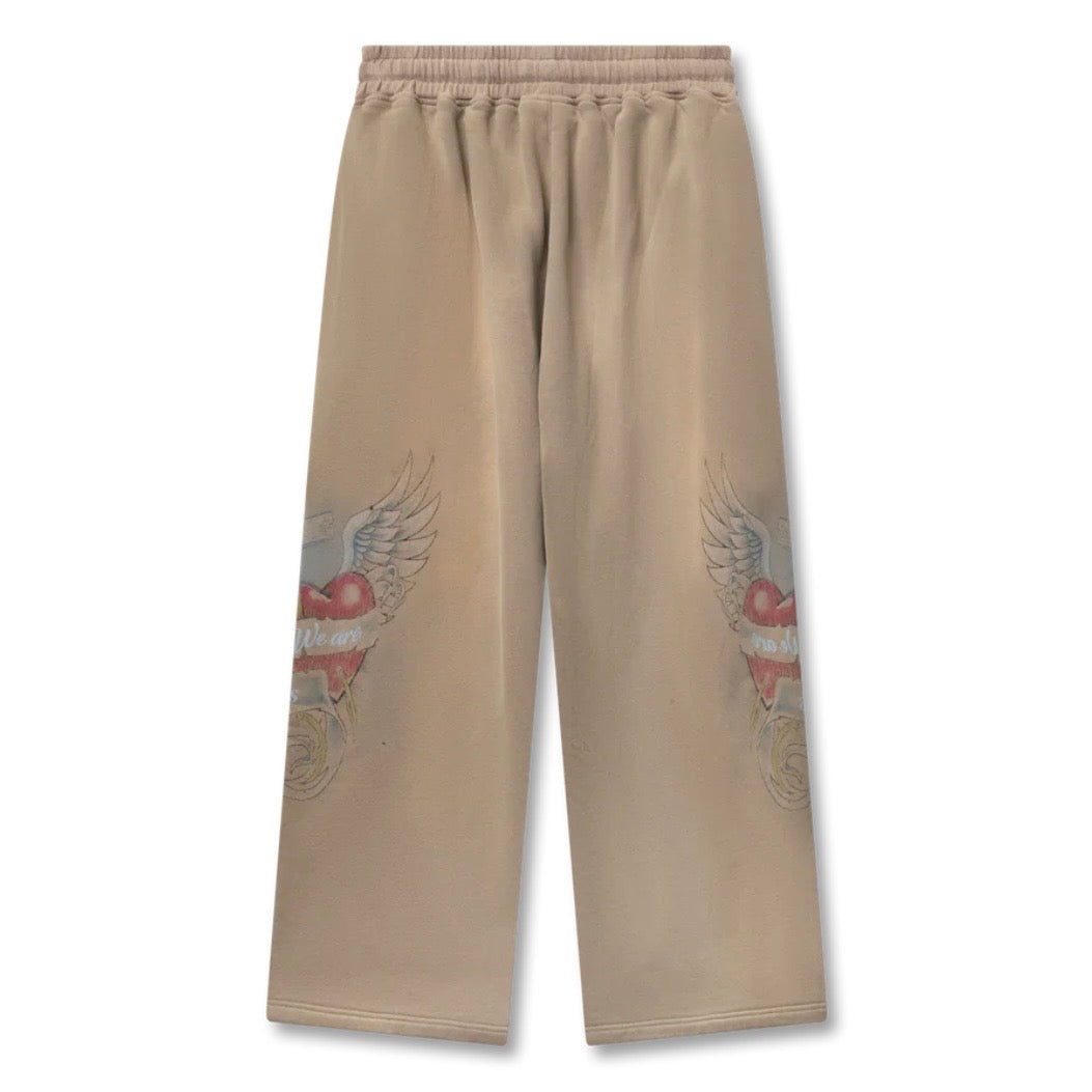 Back of washed tan wide-leg sweatpants with winged heart prints on both legs