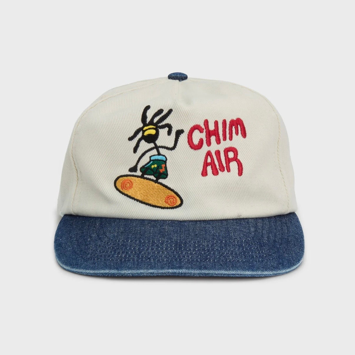 HMDD Chim Air Hat, front view of a cream cap with a denim blue brim, embroidered character and red CHIM AIR lettering