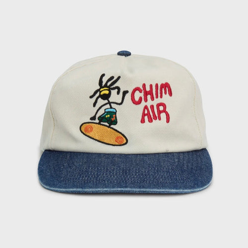 HMDD Chim Air Hat, front view of a cream cap with a denim blue brim, embroidered character and red CHIM AIR lettering