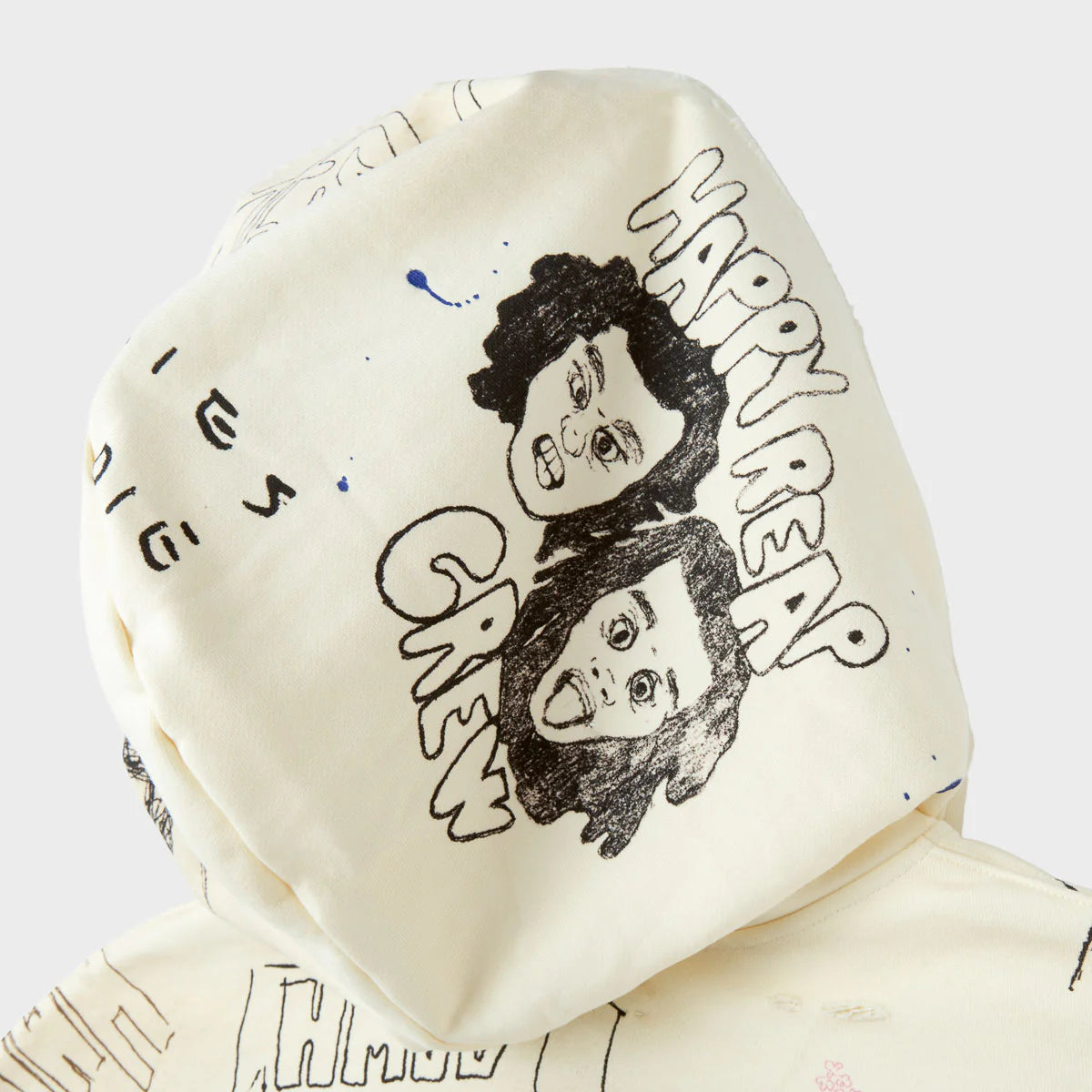 HMDD Sketch Hoodie, hood detail with two cartoon faces and hand-drawn HAPPY REAP CREW lettering on cream fabric