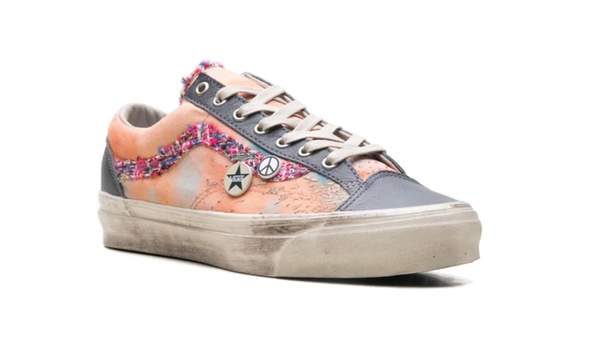 Opposite-side profile of peach Vans Old Skool with star and peace-sign enamel pins