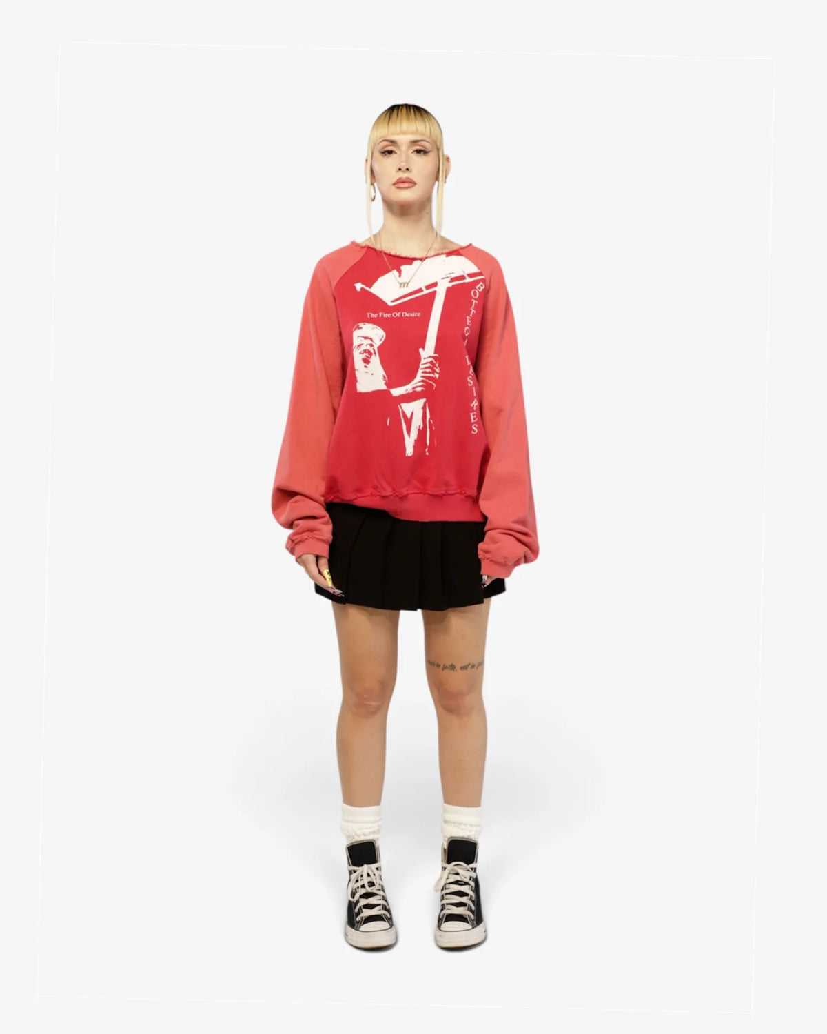 Model wearing the red Fire Of Desire crewneck with a black skirt, front view
