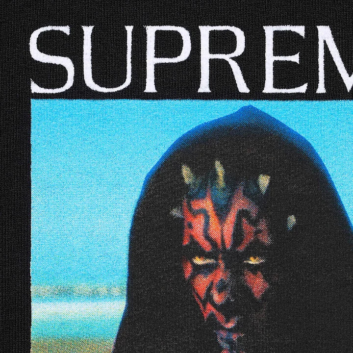 Supreme Black Sith Hoodie, close-up of the chest print with white Supreme text over the face on a blue sky
