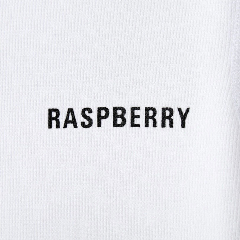 GV Gallery Kimbo Slice Thermal, close-up of the small black RASPBERRY chest print on the white waffle knit