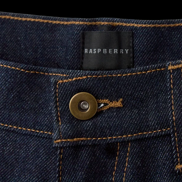 GV Gallery Belt Jorts waistband close-up with the Raspberry label and antique brass button