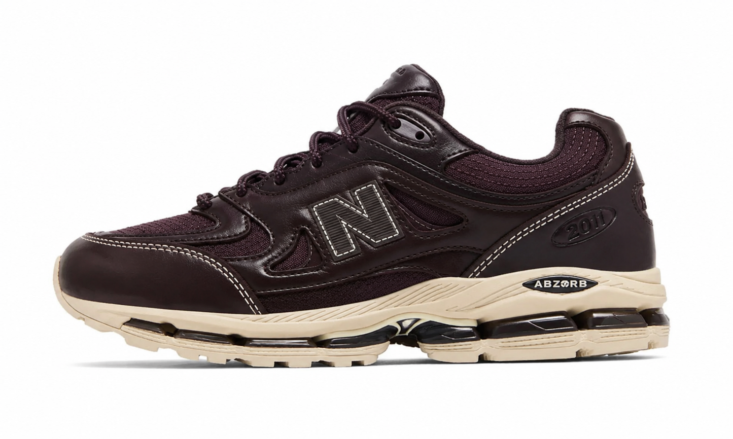 Kith New Balance 2011 Bark, side view of a dark brown leather runner with a grey N logo and cream ABZORB midsole