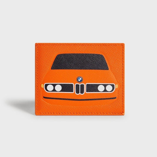 Kith for BMW CSi 3.0 Sunglow cardholder in orange saffiano leather, printed with the BMW 3.0 CSi front end - black hood, twin round headlights and chrome kidney grille