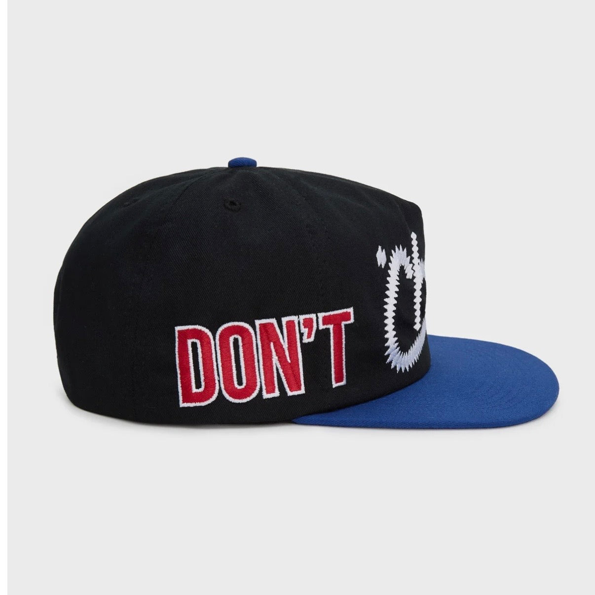 HMDD Chocolate City Hat, side view showing red DON'T outlined in white on the black crown above the blue brim