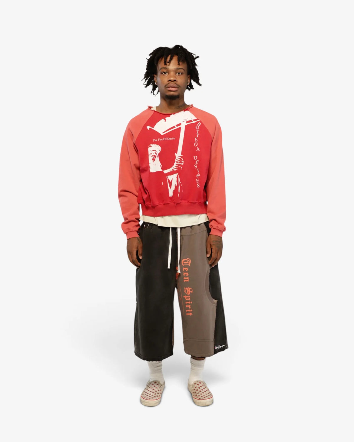Model wearing the Fire Of Desire crewneck with long shorts, front view