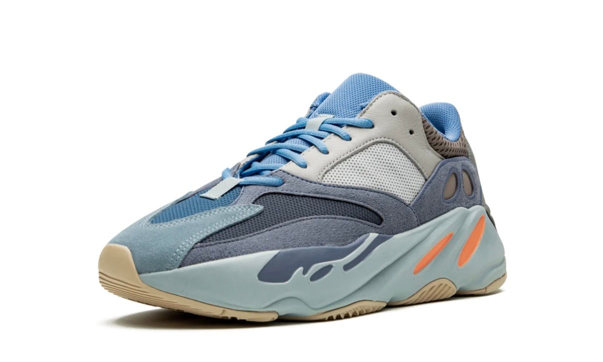 Adidas Yeezy 700 Carbon Blue, three-quarter view of one runner with light blue laces, navy panels and orange pods