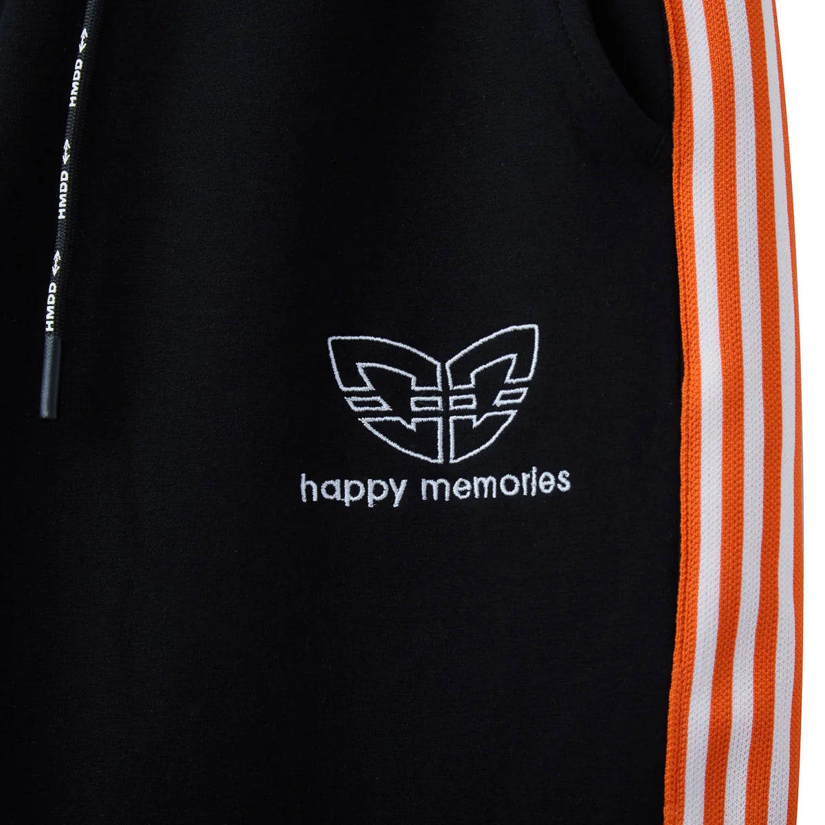Close-up of the white winged logo and happy memories text on black fleece