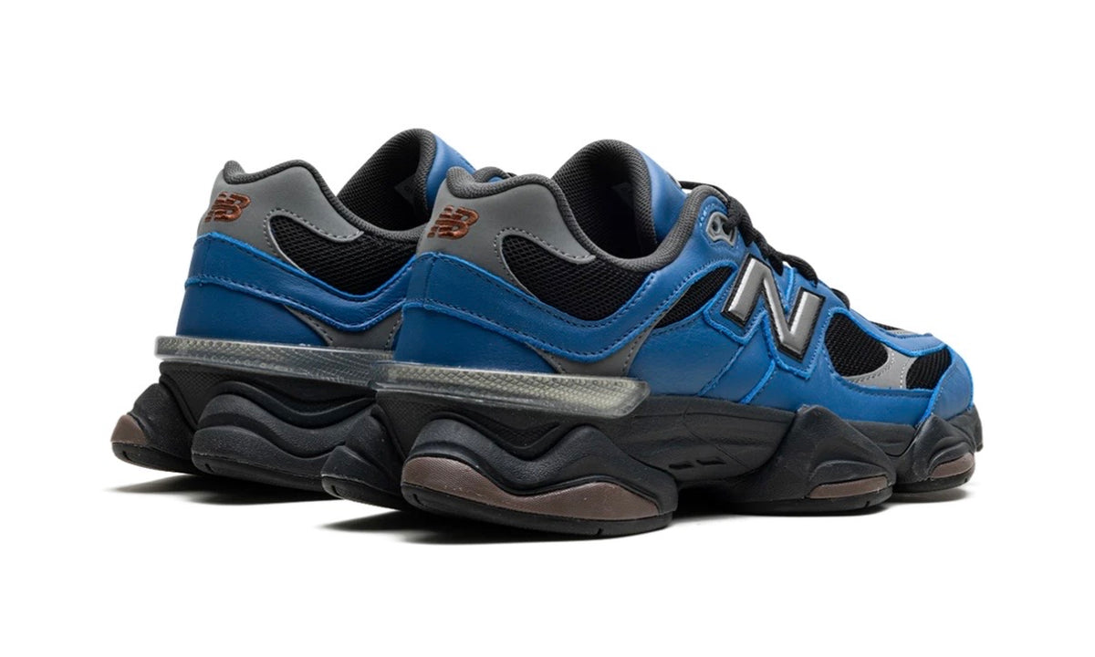 New Balance 9060 Dark Royal Brown, rear three-quarter view of the pair showing the black midsole pods and red heel logo