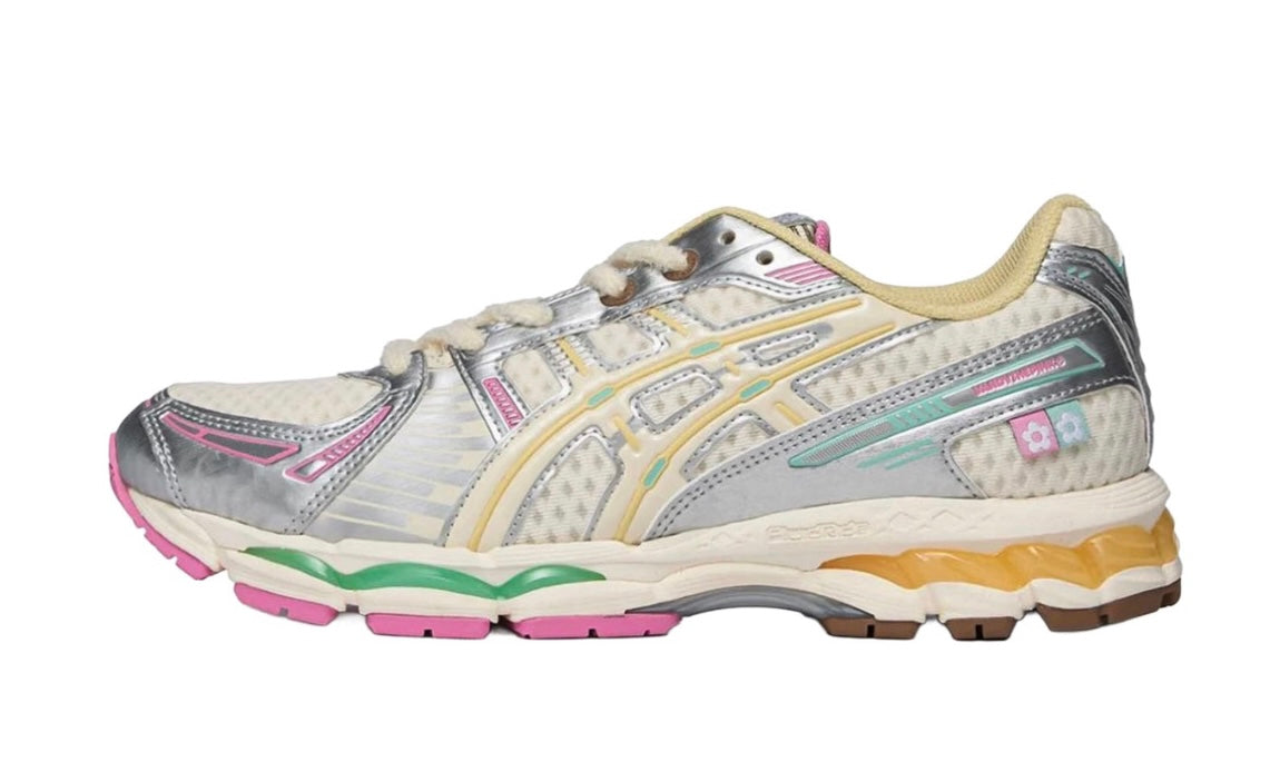 Vandy The Pink Asics Gel-Kayano 12.1 Vanilla, side view of a cream and silver runner with pink and mint green sole accents