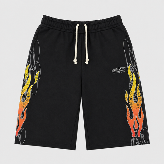 Boredom Kills Up In Flames 3/4 Shorts front flat-lay — black shorts with yellow-to-red flames climbing both legs