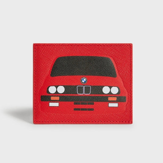 Kith for BMW M3 Cinnabar cardholder in red saffiano leather, printed with the BMW E30 M3 front end - black hood, twin round headlights, orange indicators and kidney grille