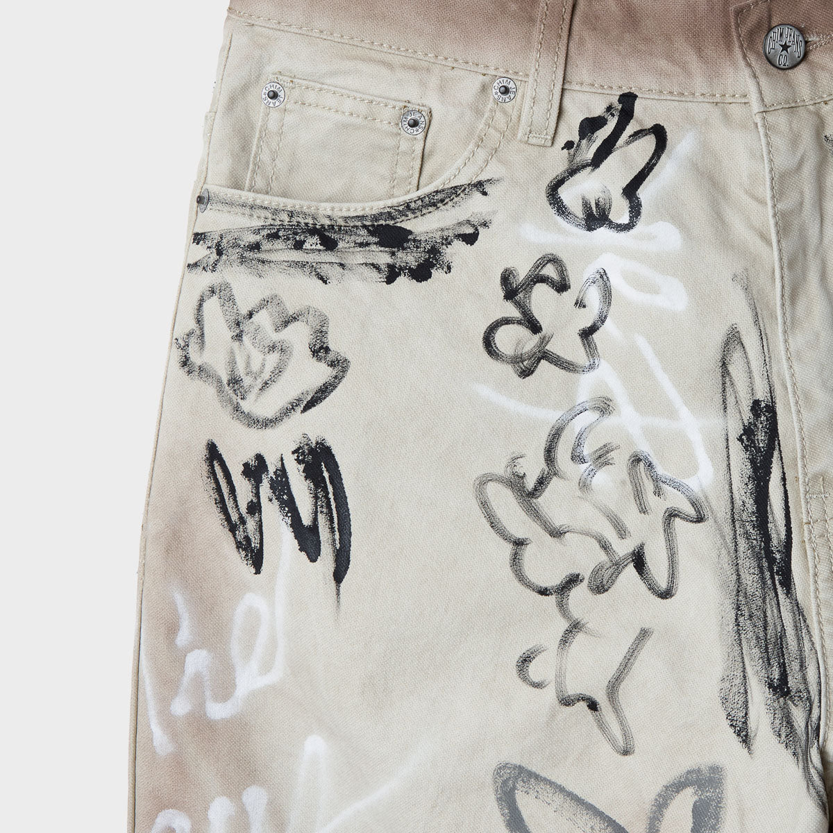 Close-up of the ecru canvas front pocket, coin pocket and metal rivets