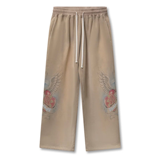 Washed tan wide-leg sweatpants printed with red and grey winged sacred hearts