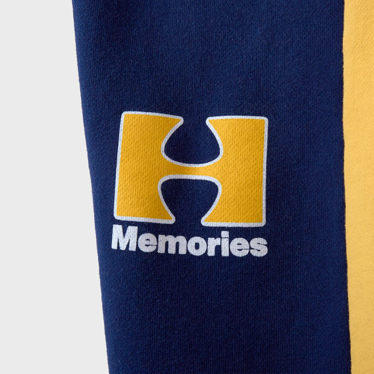 HMDD Pear Tech 3/4 Shorts close-up of the gold H and Memories logo on the thigh