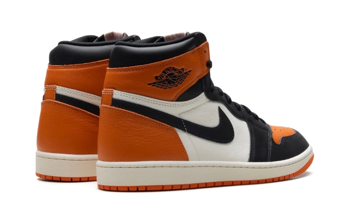 Pair of Air Jordan 1 High Shattered Backboard from the rear, orange heels and cream midsoles