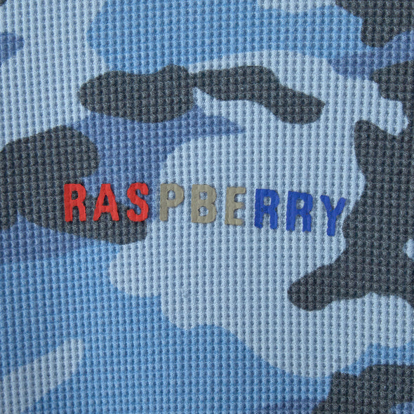 Close-up of horizontal multicolour RASPBERRY print on blue camo waffle fabric