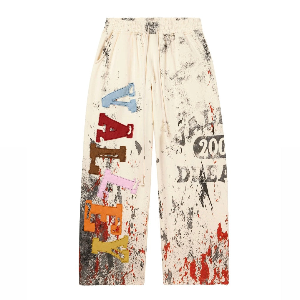 Vale Cream Picasso Sweatpants front view with multicoloured chenille leg letters and splatter print