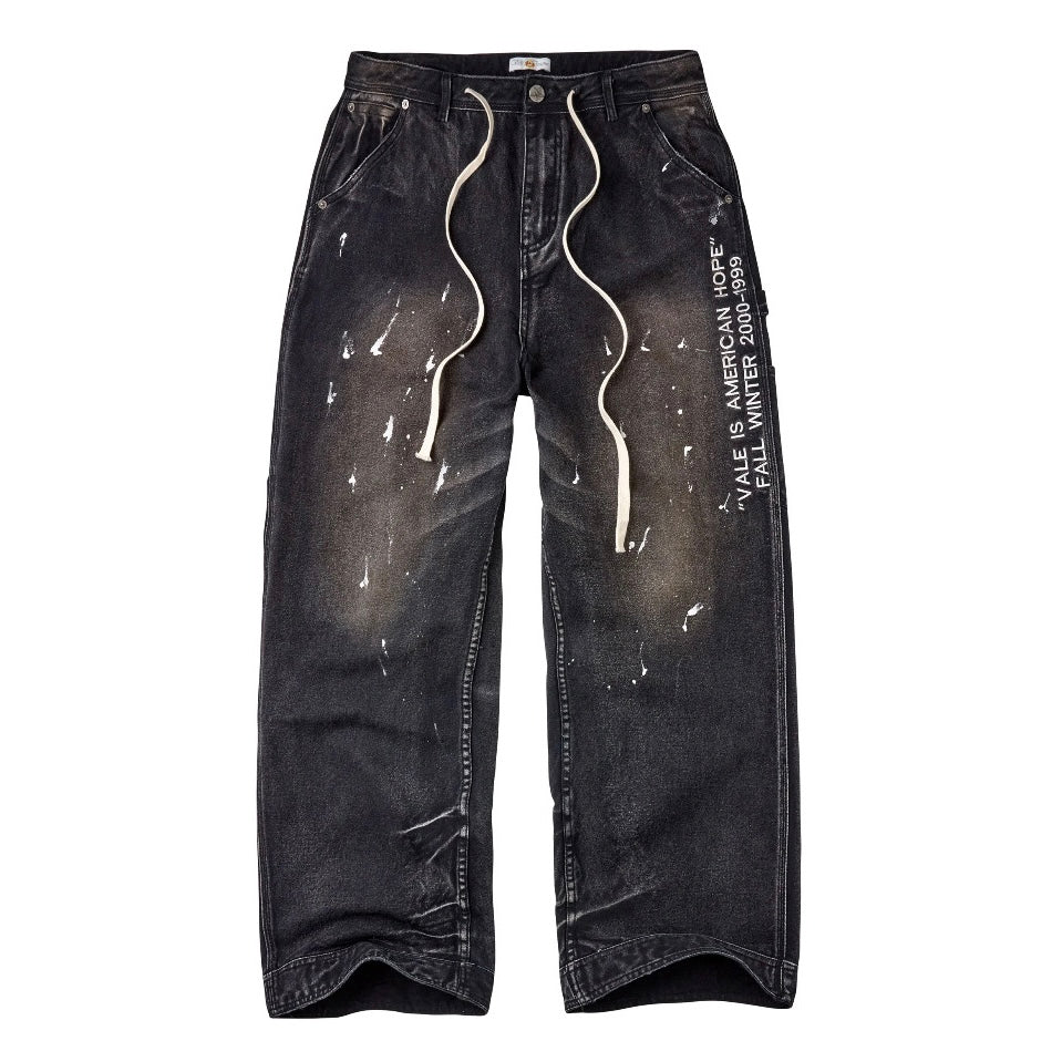 Vale Black American Hope Painter Pants, baggy faded black denim with white paint splatter, long white drawstring and side leg text