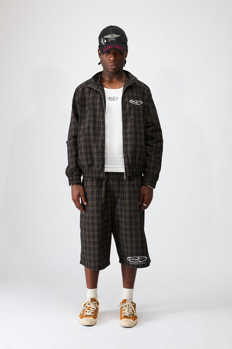 Boredom Kills Black Brown Plaid Track Shorts on a studio model with the matching plaid track jacket and cap
