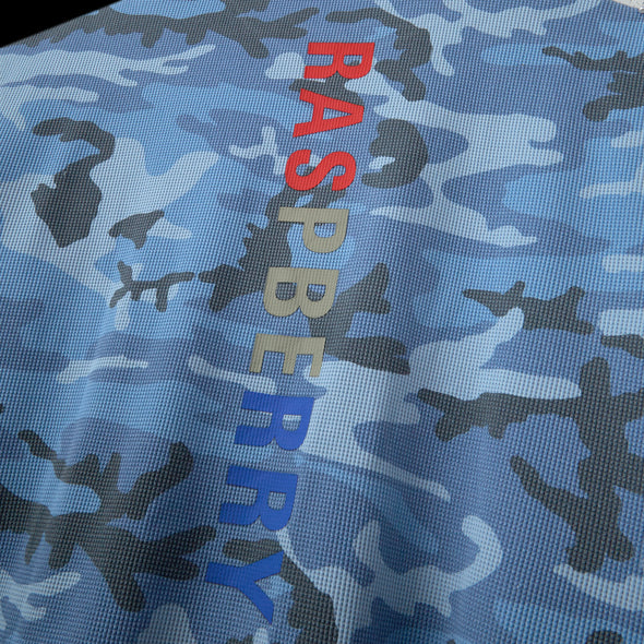 Close-up of vertical multicolour RASPBERRY print on blue camo waffle knit