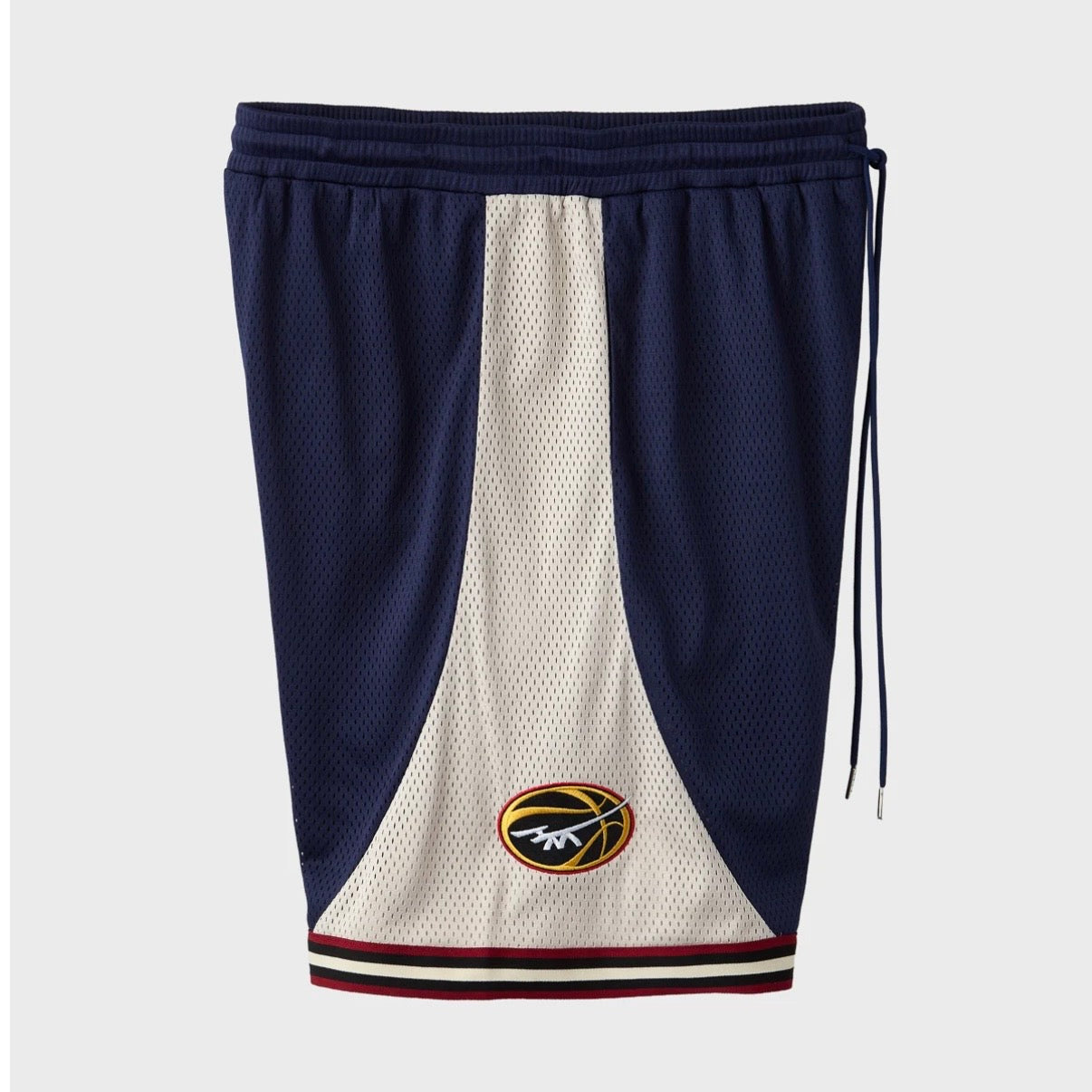 HMDD UE Basketball Shorts, angled view with the drawcord hanging and a gold basketball logo on the cream side panel