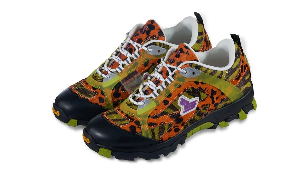 Pair of Sicko x xVessel Tiger Orange hiking shoes with white laces and animal print uppers