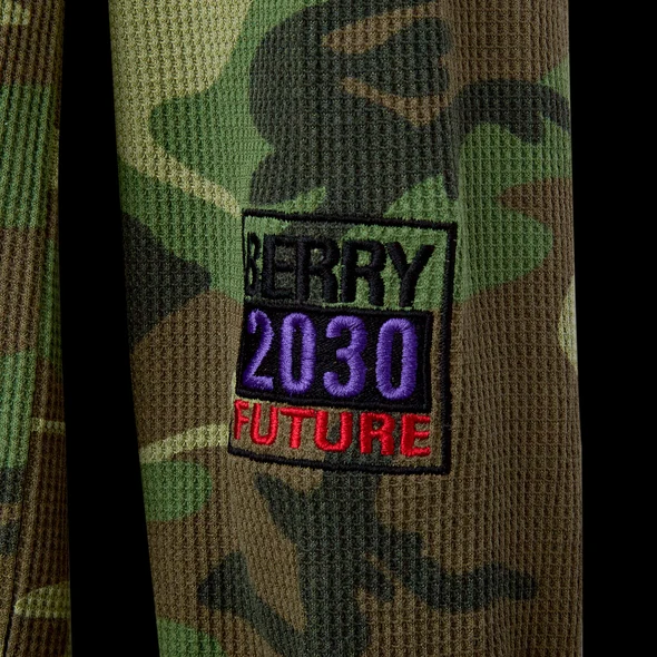 Close-up of the black BERRY 2030 FUTURE embroidered patch on green camo