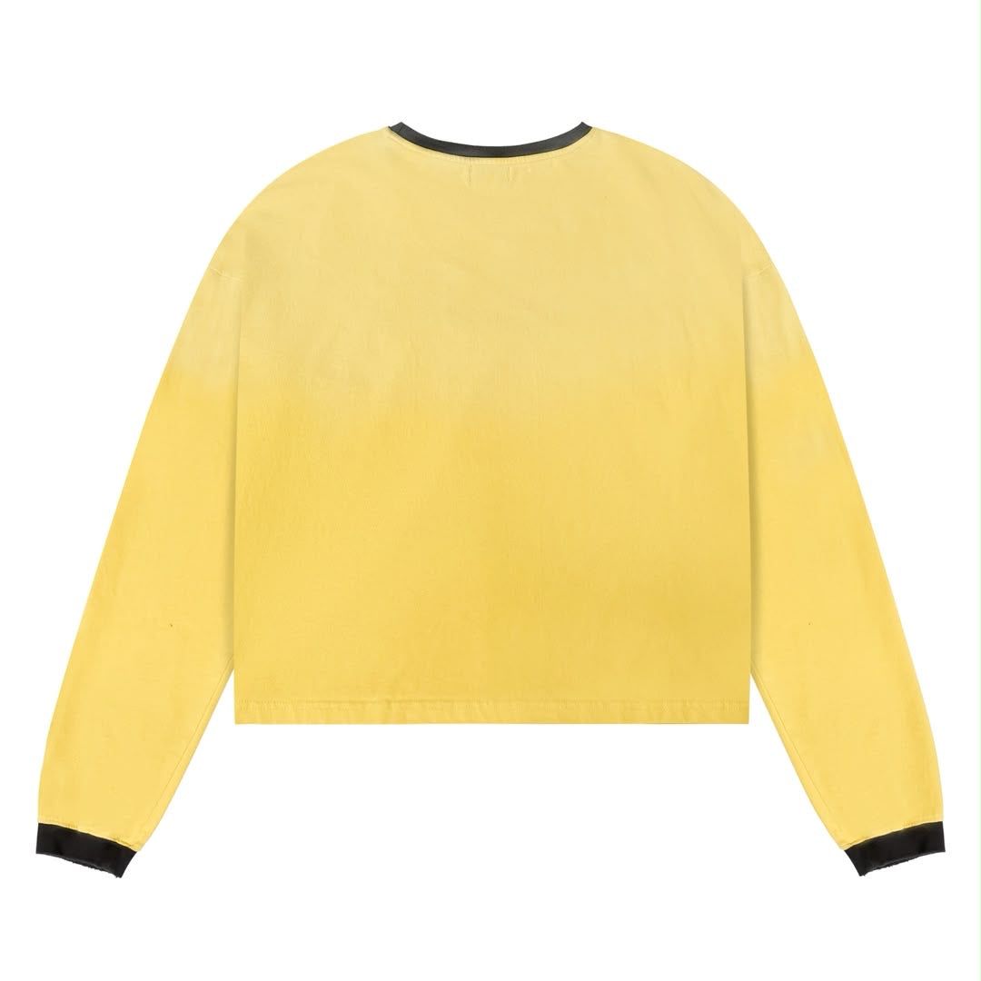 Stile De Amor Stresso Long Sleeve, back of the yellow long sleeve with black ribbed collar and cuffs