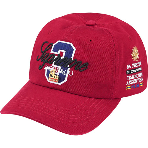 Supreme Jacob & Co La Martina Red 6-Panel Hat, front of red cap with black script over a blue shield patch and gold crest pin