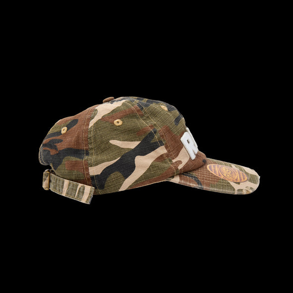 Side view of the camo dad hat showing the golden waffle patch on the brim