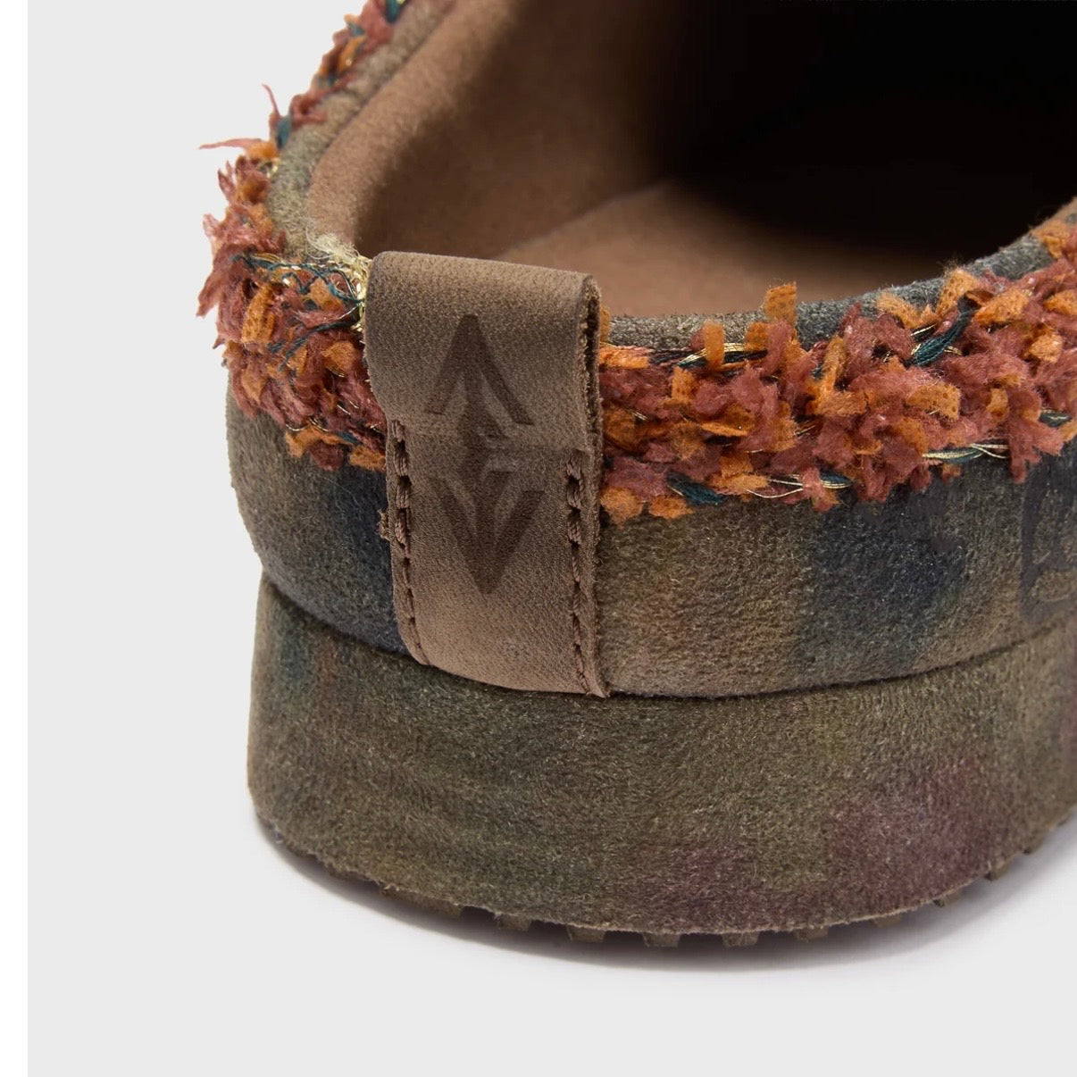 HMDD Graffiti Mule, close-up of the stitched heel tab and the orange shearling collar trim