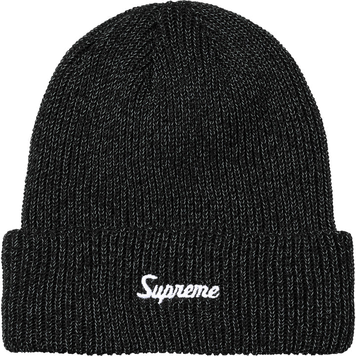 Black loose gauge reflective beanie with white Supreme script, normal lighting